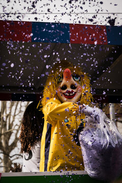Basel, Switzerland - 10 March 2025: View of a vibrant Fasnacht reveler amidst a shower of confetti, showcasing the city's festive spirit.