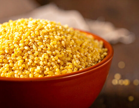 A vibrant bowl of raw fonio grains, ready for cooking a traditional Bissau-Guinean meal.