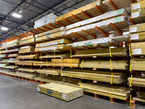 Prosper, Texas, USA - April 1st, 2026: Different sizes of Prowood and Arauco molding wood boards stacking on high orange cantilever racks in The Home Depot