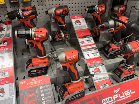 Prosper, Texas, USA - April 1st, 2026: Rows of red Milwaukee M18 Fuel cordless power drills and impact drivers standing on display shelves in The Home Depot
