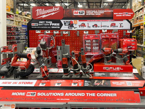 Prosper, Texas, USA - April 8th, 2026: Professional Milwaukee M12 Fuel cordless ratchets and drills on red metal pegboard shelf in The Home Depot