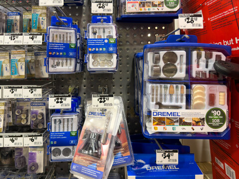 Prosper, Texas, USA - April 1st, 2026: Numerous blue Dremel rotary tool accessory kits and cutting attachments hanging on pegboard hooks in The Home Depot