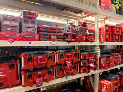 Prosper, Texas, USA - April 1st, 2026: Red and black Milwaukee Packout modular tool storage system boxes stacked on warehouse shelves in The Home Depot