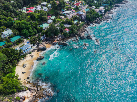 Aerial view of where turquoise waters meet the rugged coastline and lush green vegetation, Vista do Mar, Mahe Island, Seychelles.