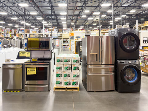 Prosper, Texas, USA - April 1st, 2026: Stainless steel GE refrigerators, ranges, and laundry machines standing next to HDX plastic sheeting in The Home Depot