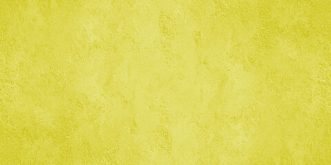 A vibrant full frame image showcasing a textured uniformly yellow background with subtle variations in tone and light © Jui