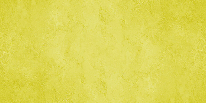A vibrant full frame image showcasing a textured uniformly yellow background with subtle variations in tone and light