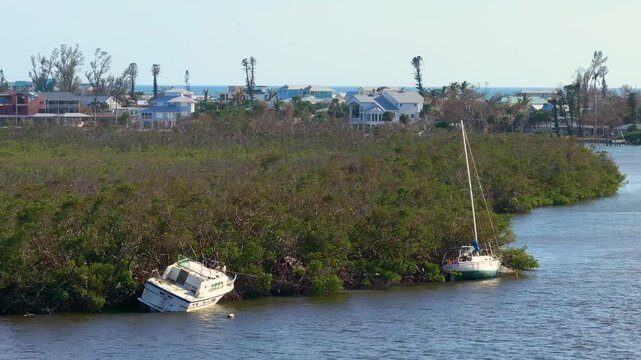 Hurricane Milton impact in Florida. Destroyed yachts after on bay shore on Manasota Key.