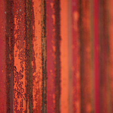 View of layered rust and faded orange paint create a textured and weathered industrial surface with a sense of decay and history, Dronten, Netherlands.