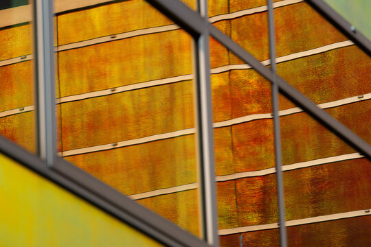 View of warm light reflecting and refracting through the geometric architectural window panes, creating a mesmerizing display of color and form, La Defense, Netherlands.