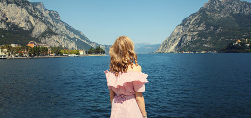 Summer vacation, beautiful woman tourist stands enjoying amazing sea landscape, mountains background © rohappy