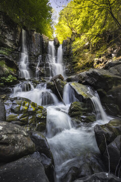 View of cascading waterfalls tumble down moss-covered rocks, a symphony of nature's power and serenity in the lush embrace of the forest, Lizzano In Belvedere, Emilia-Romagna, Italy.