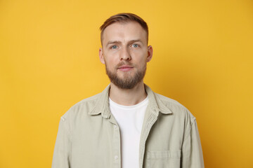 Fototapeta premium Portrait of handsome man on orange background