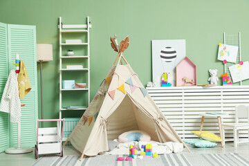 Cute wigwam and toys in stylish child's room © New Africa