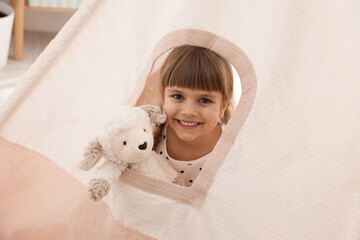 Little girl with toy sheep in wigwam at home © New Africa