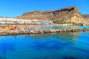 Fototapeta premium The sandy Playa de Mogán, a popular sandy beach and tourist resort in Puerto de Mogán, located on the southwestern coast of the island of Gran Canaria in Spain. 