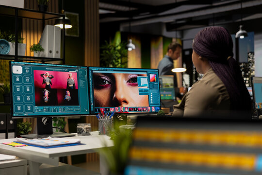 Black woman editor using AI powered media content for image retouching, working on contrast adjustments. Graphic designer employs futuristic interface for his portfolio, artificial intelligence.
