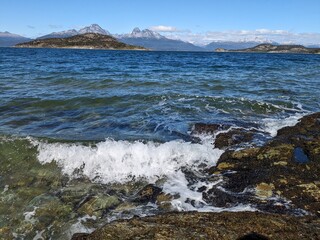 Fototapeta premium Wave Crashing on Rocky Shoreline in Beagle Channel, Ushuaia, Tierra del Fuego