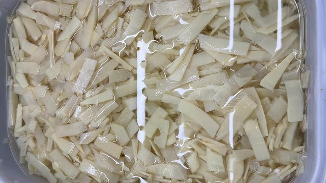 Fresh bamboo shred shoots in a bowl of water
