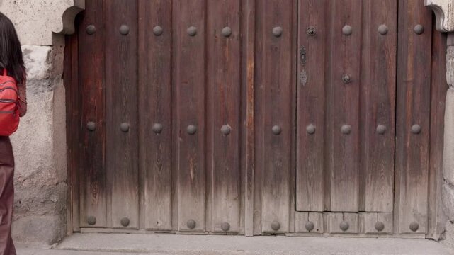 Happy young woman dancing while walking in the street. door, Background,