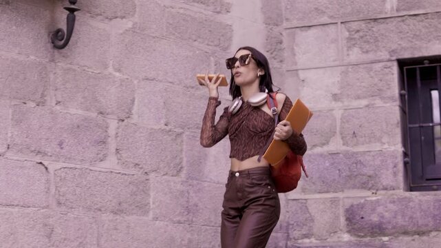 Happy university student dancing and sending voice message