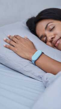 Smart fertility tracker wristband during sleep, wearable sensor for ovulation tracking and basal body temperature monitoring, femtech health data collection, hormonal cycle analytics, home care