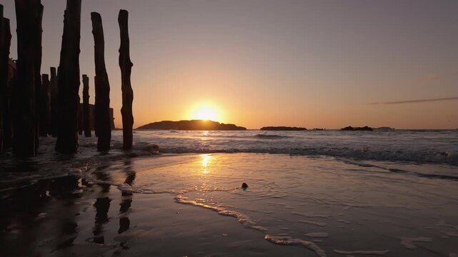 Wooden groynes of Saint-Malo at sunset