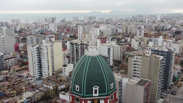 Aerial close-up drone shot of the dome and Virgin Mary statue, Iglesia del Inmaculado Coraz&oacute;n de Mar&iacute;a, Lima, Peru