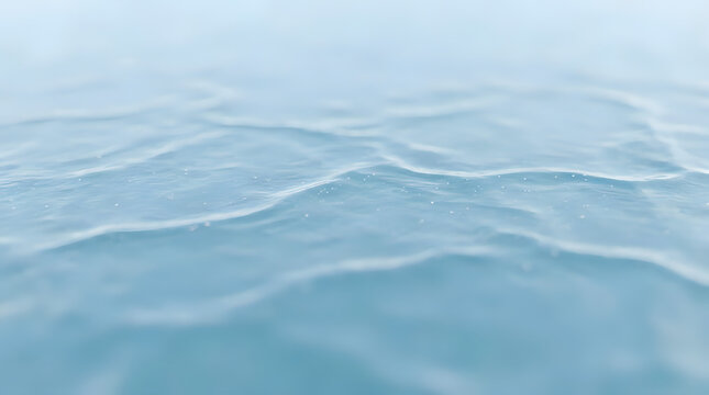 Serene light blue water surface, gentle ripples creating a calming natural background. Abstract liquid texture, tranquil aquatic pattern for peaceful designs.