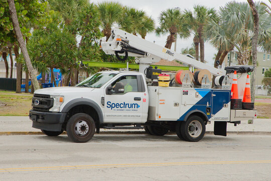Spectrum Bucket Truck Parked On Roadside For Telecom Service And Cable Maintenance Near Palm Trees Editorial Use Only St. Pete Beach,  FL USA April 7, 2026. Reels, traffic cones and a raised boom amid