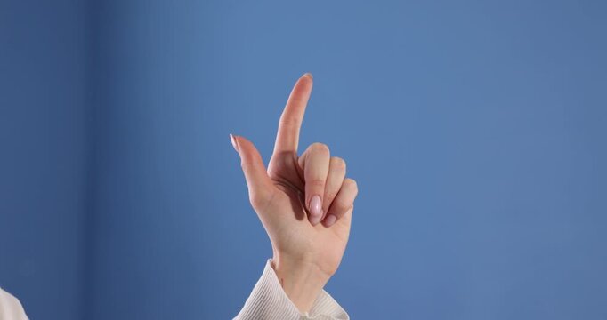 Woman showing idea gesture on blue background, closeup