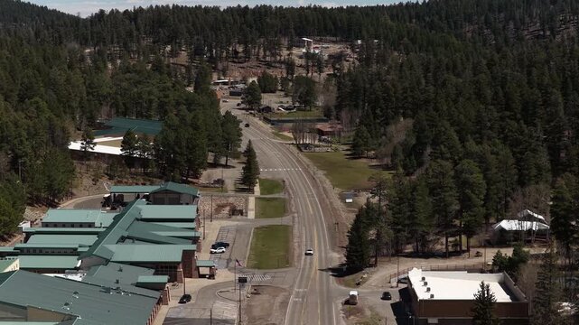 Aerial of street buildings and high school in Cloudcroft New Mexico mountain village in spring time