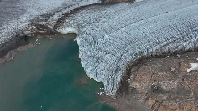 Drone shot of a massive glacier ending at the ocean near Kulusuk in East Greenland