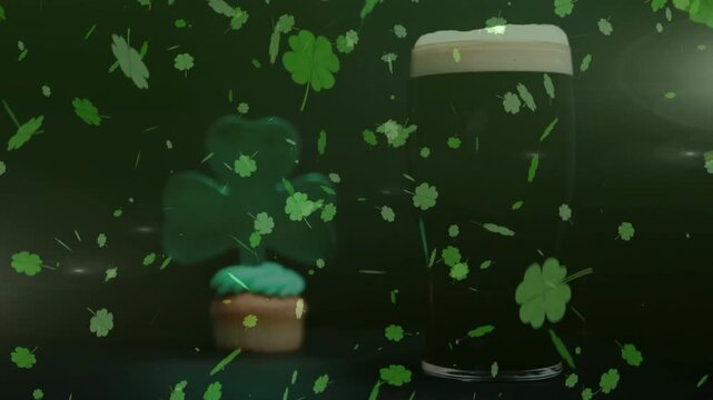 Vertical video: Falling clovers adding motion on set, obscuring shamrock cupcake and pint glass