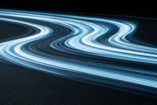 Multiple luminous blue streaks sweep in graceful curves across a dark ground, creating a futuristic sense of speed and technology ideal for innovation, data, or transport concepts.