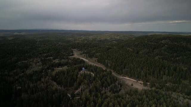 Aerial over Sunspot Highway scenic byway in Cloudcroft New Mexico in spring stormy sky