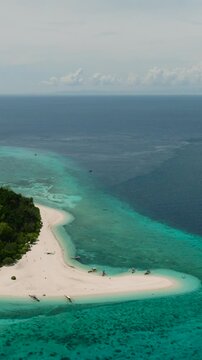 Mantigue Island with sandbar. Greenish water and corals. Camiguin, Philippines. Vertical video.