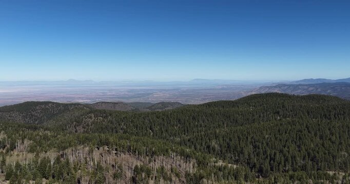 Aerial panning around Lincoln National Forest in Cloudcroft New Mexico on sunny spring day