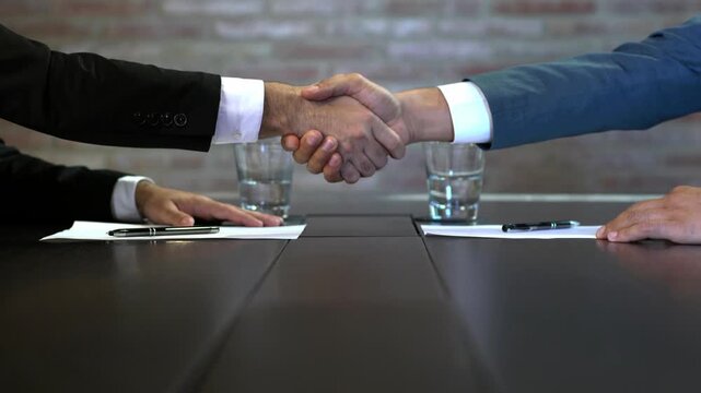 Business partnership handshake and contract signing in conference room, celebrating successful win-win collaboration video.

