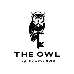 Fototapeta premium Black wise owl perched with antique old skeleton key for knowledge wisdom security mystery Logo Design
