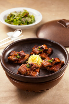 Grilled Eel Glazed with Soy Sauce Served in Traditional Korean Earthenware Onggi with Ginger