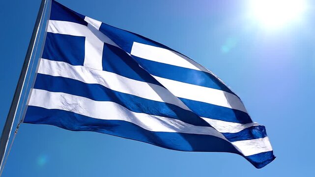 Greek flag waving in the wind with blue sky and sun