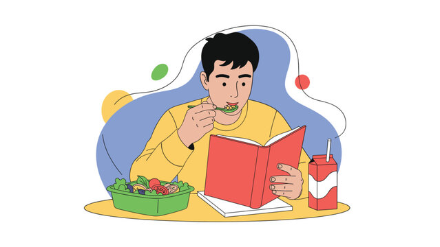 Young male student eating a healthy salad and drinking milk while focused on reading a book at a wooden table.