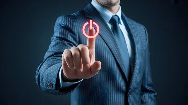 Businessman activates a glowing red digital power button on a dark background