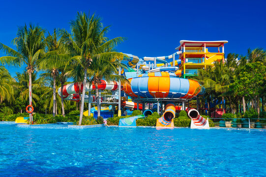 water park in the pool at resort on summer vacation. Colorful aquapark with slides