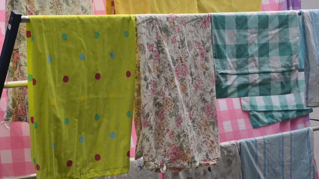 Assorted Colorful Laundry Drying On A Clothesline With Bright Sunlight And Gentle Breeze