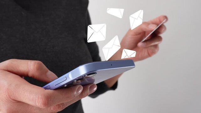 Businesswoman holding a bank card while holding a phone with an animation of several mail envelopes rising. Arrival of several emails.