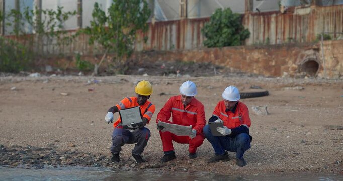 Engineers and technicians inspect a water source beside refinery drainage in the evening, supporting environmental monitoring, safety compliance, and industrial risk control.
