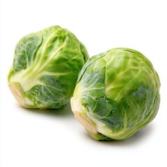 Obraz premium Two whole fresh green Brussels sprouts with natural stems isolated on a white background