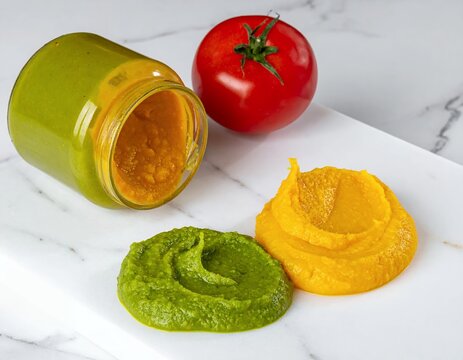 Fresh Homemade Baby Food Purees with Tomato and Jar on Marble Surface.
